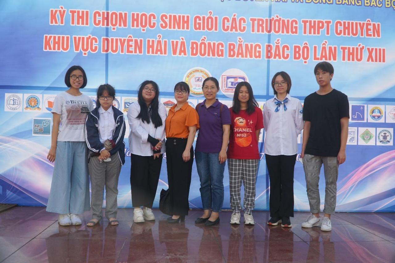 A group of people posing for a photo</p>
<p>Description automatically generated