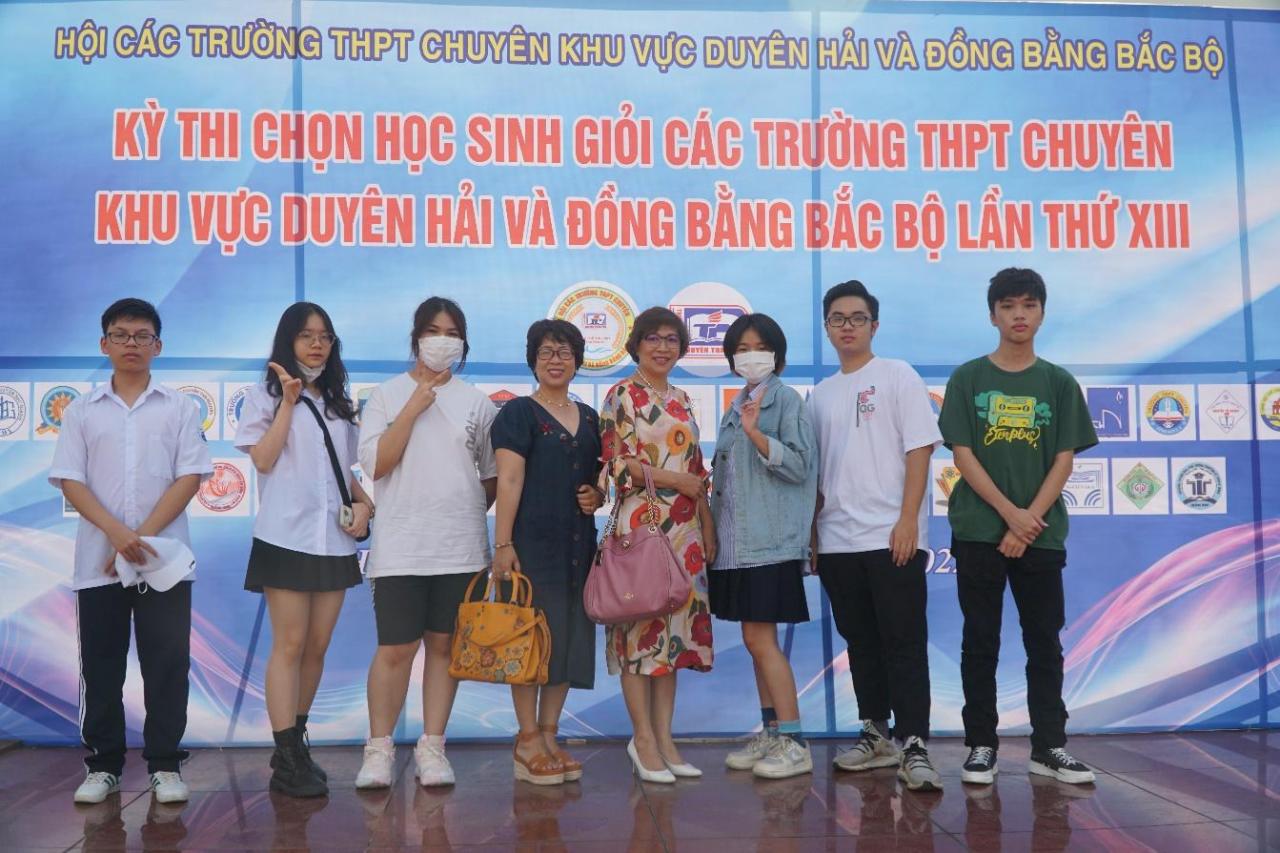 A group of people posing for a photo</p>
<p>Description automatically generated