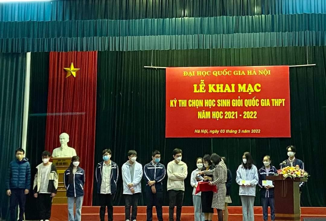 A group of children standing on a stage with a sign behind them</p> <p>Description automatically generated with low confidence
